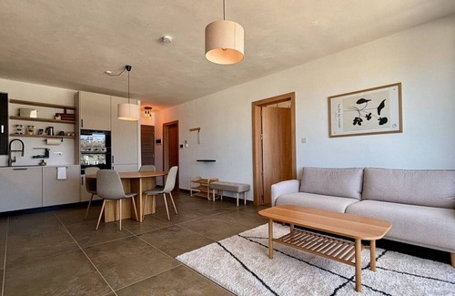 Mellieħa Heights Apartamento | Step inside to discover a modern and elegantly decorated space, featuring two spacious bedrooms with ample storage, ensuring a restful and convenient stay. The open-plan living area boasts contemporary furnishings, providing a chic and cozy atmospher