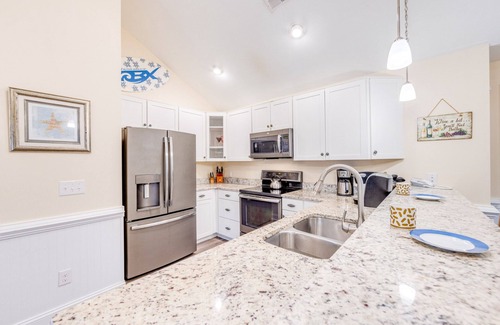 Hatteras Condominio | SUMMER SAVINGS - Canalfront Condo w/ Private Deck, Resort Pool, and Boat Slips