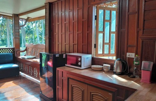 Thong Chai Casa | Traditional Thai wooden house on stilts set in a coconut orchard near the beach