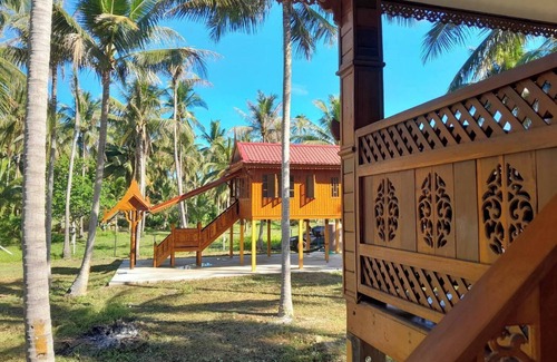 Thong Chai Casa | Traditional Thai wooden house on stilts set in a coconut orchard near the beach
