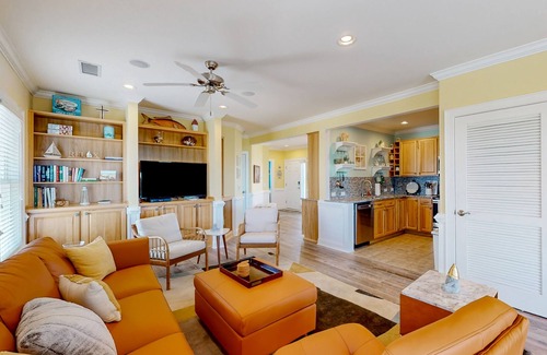 Hatteras Condominio | Vibrant beach retreat with washer/dryer, central AC, deck, & pool access