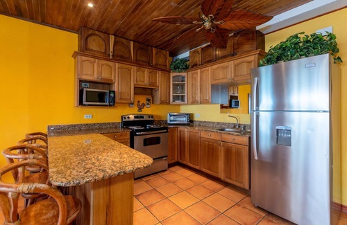 Playa Flamingo Condominio | Warm Interiors and Orange Hues on Ground Floor in Front of Beach