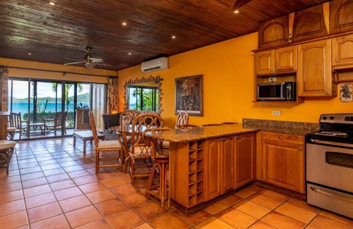 Playa Flamingo Condominio | Warm Interiors and Orange Hues on Ground Floor in Front of Beach
