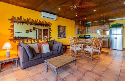Playa Flamingo Condominio | Warm Interiors and Orange Hues on Ground Floor in Front of Beach