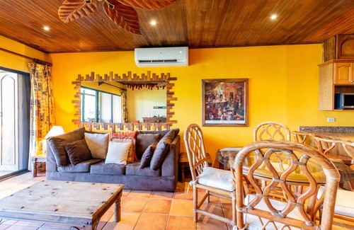 Playa Flamingo Condominio | Warm Interiors and Orange Hues on Ground Floor in Front of Beach