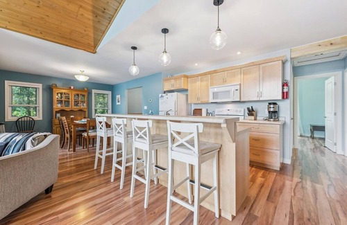 Miller Lake Cabaña | Watersedge: 4BR Miller Lake cottage with dock, firepit, decks, spacious interiors, rec room & foosball.
