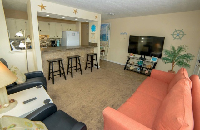 Charming 1Br Condo on the beach with pool outside back door and beach access.