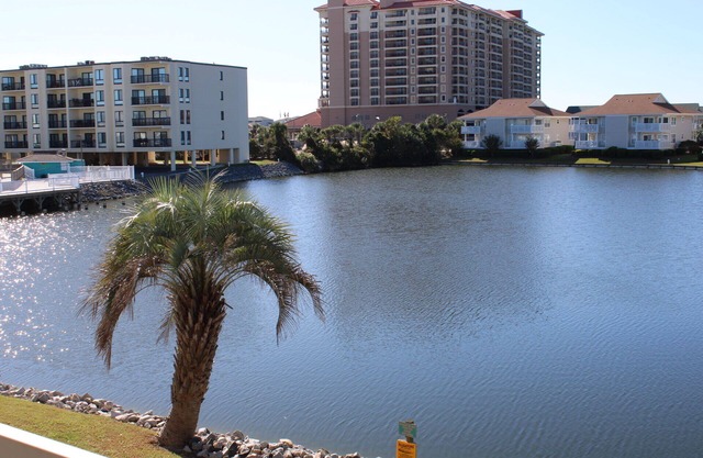 Charming 2-bedroom condo offering serene living with picturesque pond vistas, with a lovely pool!