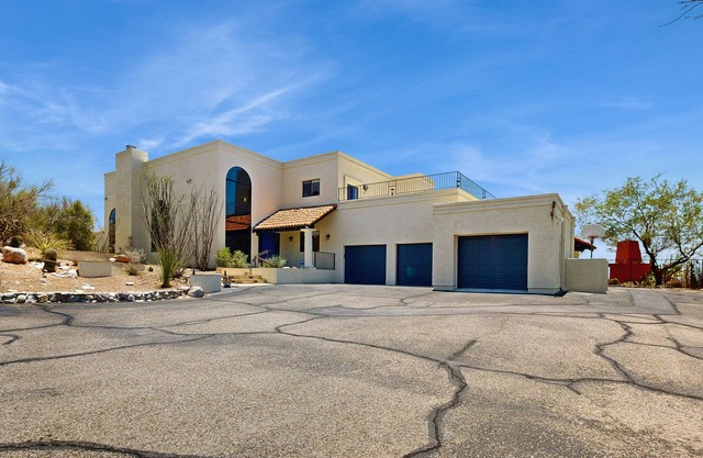 Dazzling retreat with city views, pool, hot tub, bocce ball court, & roof deck