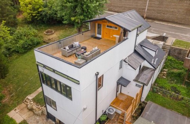 Downtown skyline vista featuring giant rooftop deck & wet bar with a city view