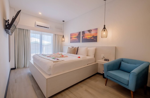 Enjoy a gorgeous master suite with a full kitchen, king bed, and balcony!