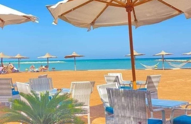 G.3.11 Red Seafront apartment. Restaurant on beach, lounge chairs, umbrellas