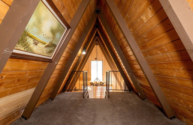 Knotty Pine Chalet has a huge front deck and fully fenced yard .