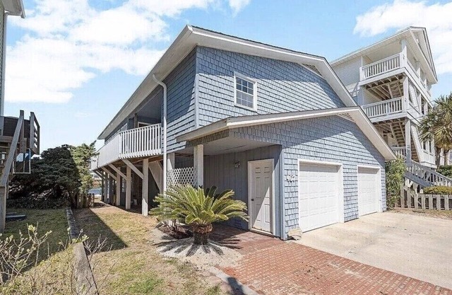 Located directly on canal w/ beautiful water front views — one block from beach