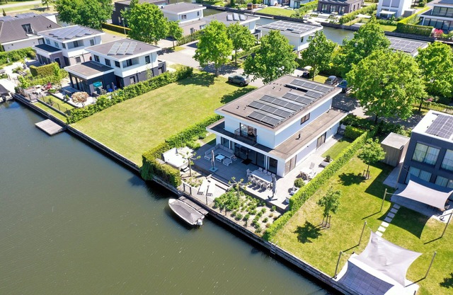 Luxury 10-person villa with jacuzzi, sauna, 4 bedrooms, 3 bathrooms and two outdoor dining tables. Pet-friendly, fully equipped kitchen, and direct water access.
