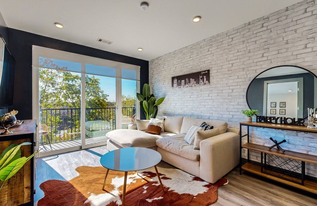 Modern Muse downtown condo with private balcony, central AC, & rooftop lounge