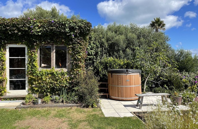 Private sunny oasis with twin sea views and a cedar hot tub.