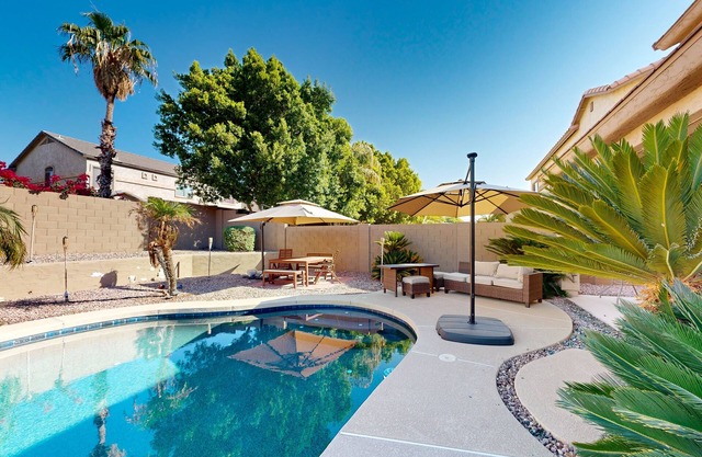 Spacious home surrounded by palms with pool, grill, children's items, & W/D