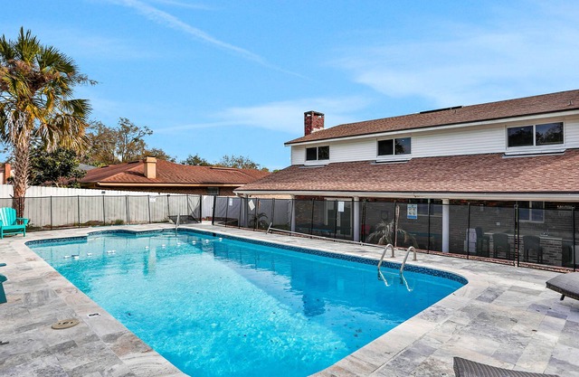 Spacious home with pool, game room, wet bar, grill, & covered patio