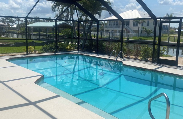 Sunny Getaway – Heated Pool, Canal Views, Walk to Beach