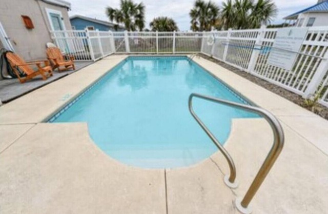 TROUT Steps to beach. Lovely two bedroom with screened porch and pool.