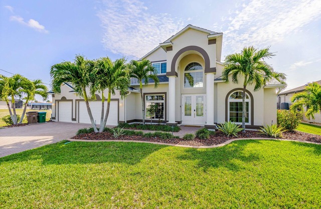 Waterfront dog-friendly house with pool, dock, pool spa, patio & sunrise views