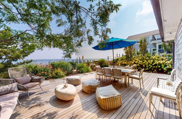 Waterfront home with large decks, chef's kitchen, parking, & direct beach access