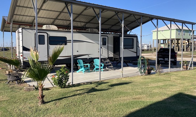 Port Bolivar Casa | 10 minutes walk to the beach .Covered rv spot on concrete slab. NEW CAMPER