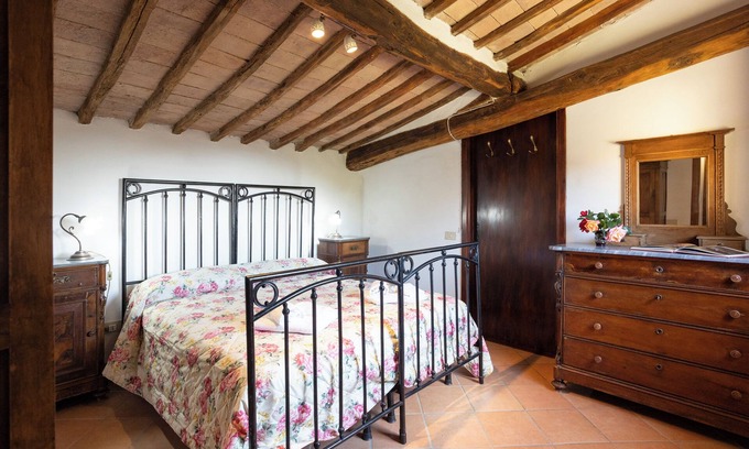 Siena Casa | Attic room with exposed beams, rustic Tuscan style