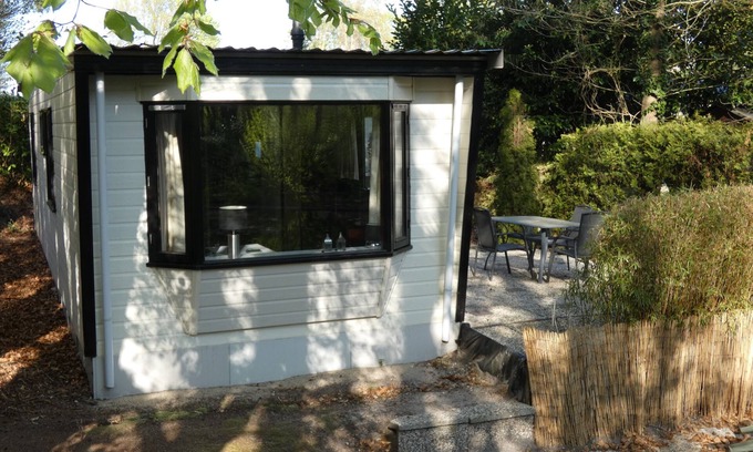 Marum Chalet De Esquí | Beautiful chalet for rent overlooking ornamental pond against forest + parking lot