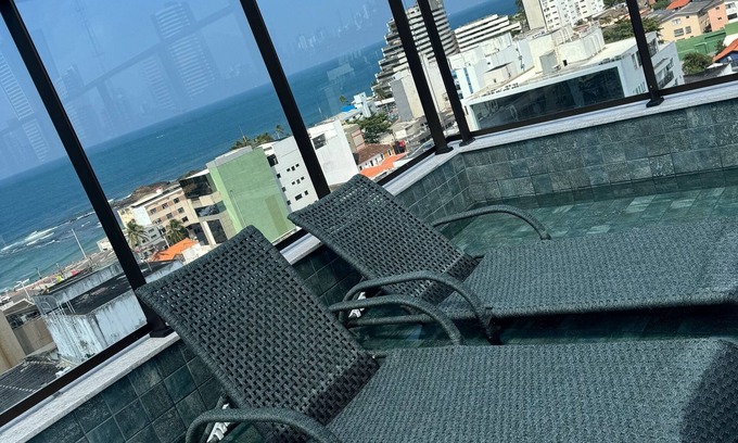 Ondina Apartamento | Bedroom and living room in Ondina, Salvador, Bahia, decorated