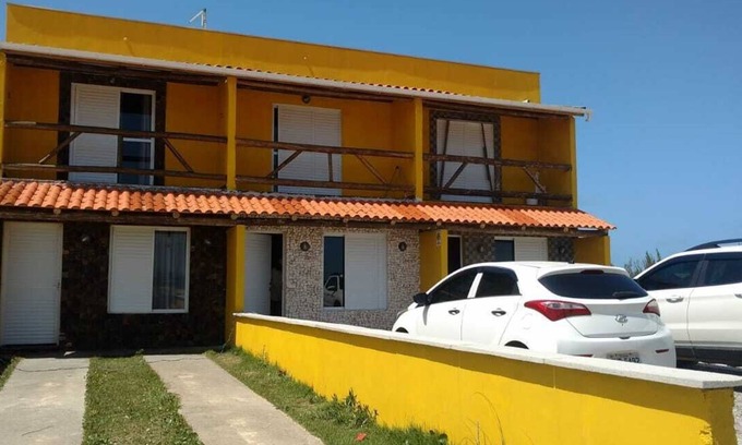 Jaguaruna Casa | Casa Pedra Ferrugem Balcony with hammock and sea view - 180m from the beach