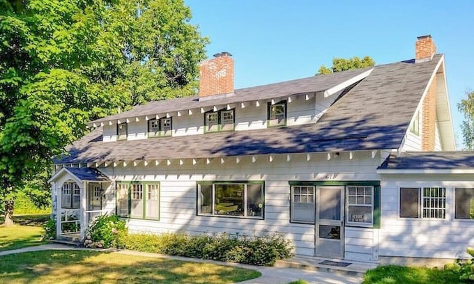 Lake Leelanau Cabaña | Classic 1920 cottage on huge lot with boat dock, fire pit patio, beautiful views