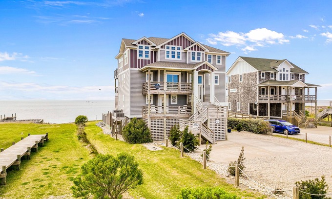 Salvo Casa | Dazzling waterfront home with balconies, private pool, hot tub, & game room