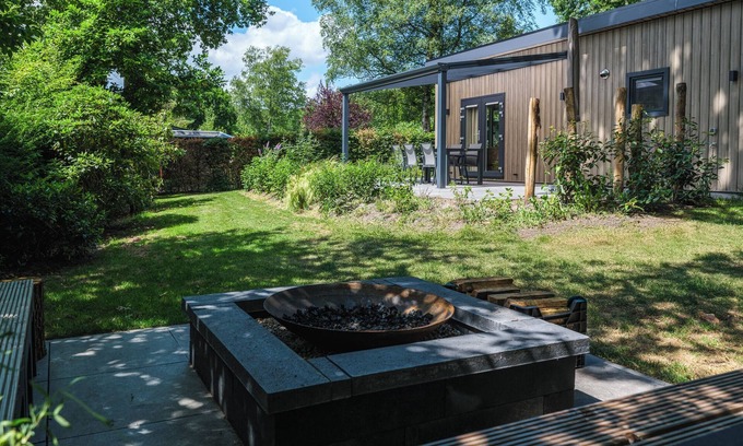 Lieren Casa | Enjoy a luxurious holiday home for 4 people in the wooded nature of the Veluwe, complete with modern amenities, air conditioning, a stylish pergola, and a cozy lounge area with an outdoor fireplace for ultimate comfort and ambiance, both day and nigh