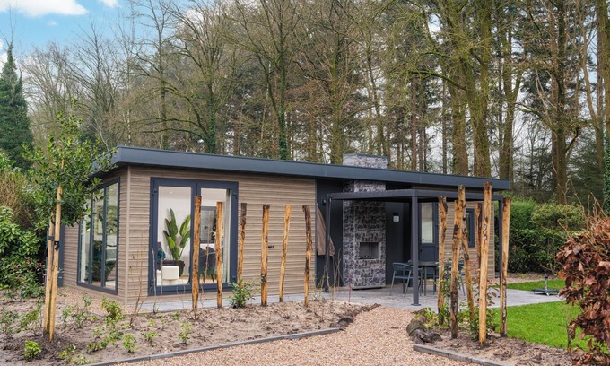 Lieren Casa | Enjoy a luxury holiday home in the wooded nature of the Veluwe, featuring modern amenities, air conditioning, and a stylish pergola with electric fireplace for optimal comfort.