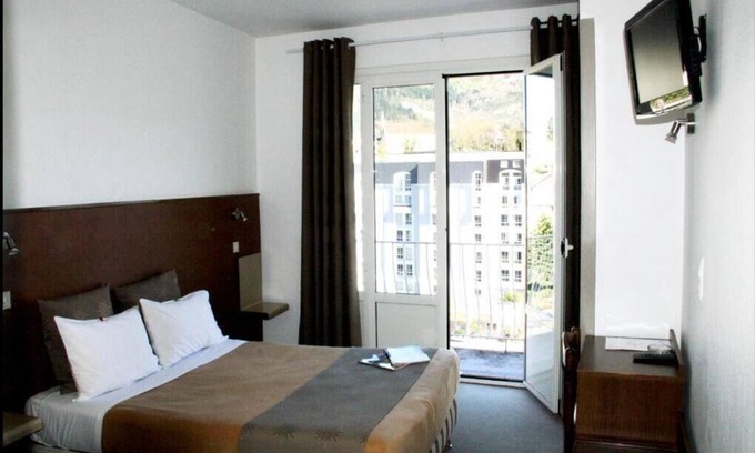 Lourdes Hotel | Enjoy Homelike Comfort & Balcony Sights w/Modern Amenities in Lourdes