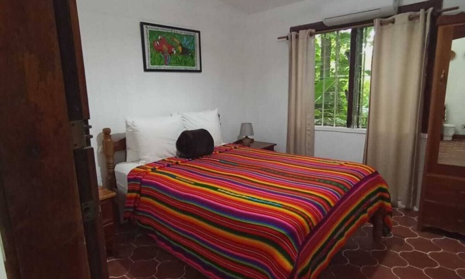 San Ignacio Apartamento | Experience comfort and relaxation in our air-conditioned apartment, featuring two spacious bedrooms, a welcoming living room, a fully equipped private kitchen, and a well-appointed private bathroom. Perfect for families or groups.