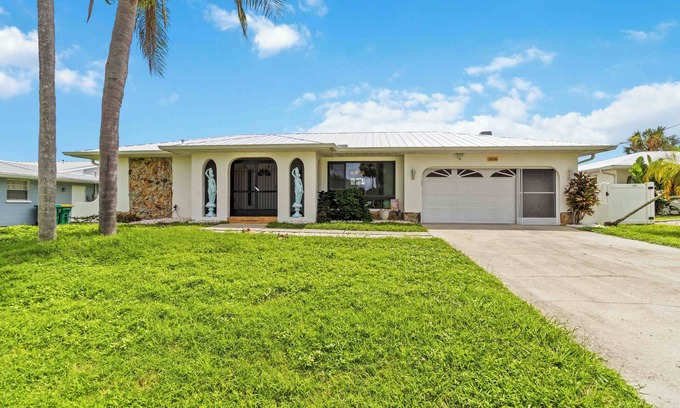 Port Charlotte Casa | Experience serenity in this fully furnished 3-bed, 3-bath waterfront home featuring a heated pool, spacious layout, and abundant natural light. Enjoy stunning water views from the master suite, living room and Florida room.