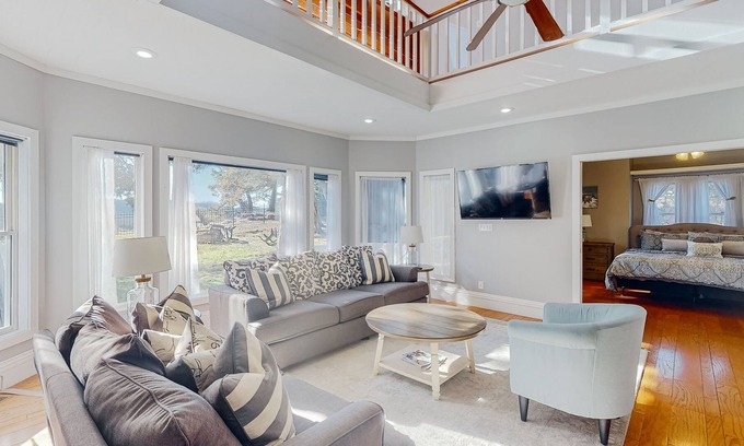 Holiday Island Casa | Gorgeous water view home with a fireplace, outdoor space & central AC