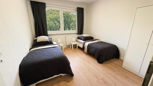 Stadtbezirk West Apartamento | Monteurwohnungen mit TV, Internet, Parkplatz, Waschmaschine, Küche, Balkon, Restaurants und Supermarkt