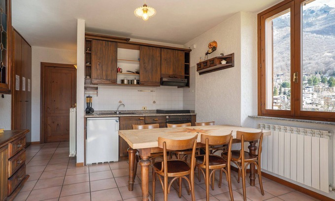 Barzio Apartamento | Mountain lodging with fireplace and mountain view