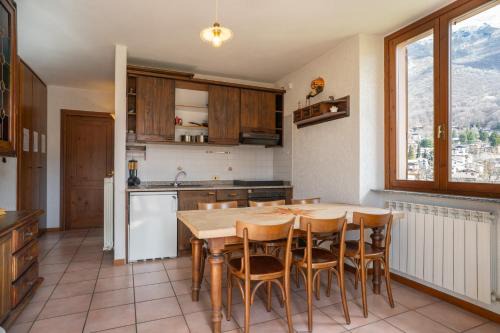 Barzio Apartamento | Mountain lodging with fireplace and mountain view