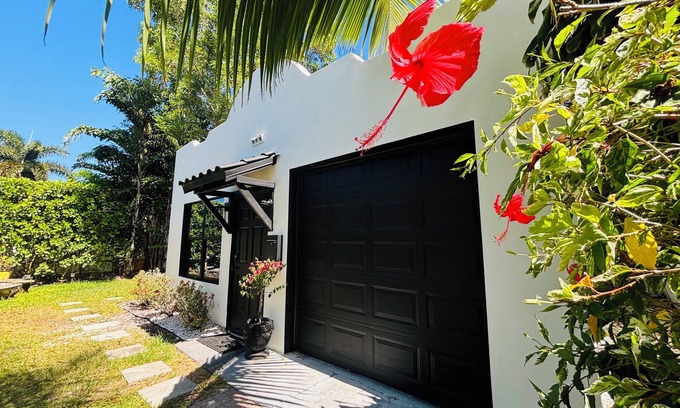 Southwest Cabaña | Palm beach cottage in zen tropical setting near beach & shops.