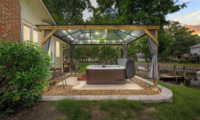River Bend Casa | Quiet Riverfront 3BR/2BA house with Spa, Dock, and Golf Carts