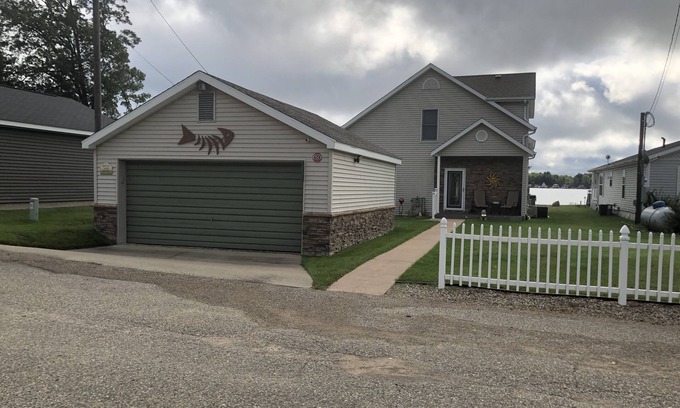 Lake Casa | Relax at the outdoor firepit or hot tub overlooking all-sports Eight Point Lake!