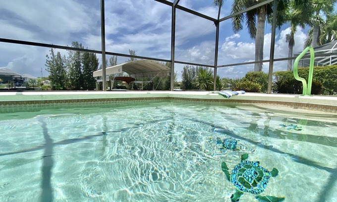 Burnt Store Casa | Relax!! Canal Home, Sunsets, Heated Pool, Lanai with TV, Boat Dock, Gulf Access