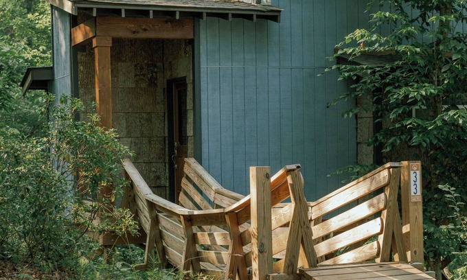 Mill Spring Casa | Romantic treehouse nestled on the creek, private deck, loft bedroom, shower skylights, bridge, sleeps 3.
