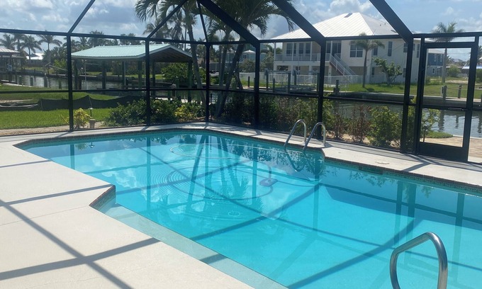South Island Casa | Sunny Getaway – Heated Pool, Canal Views, Walk to Beach