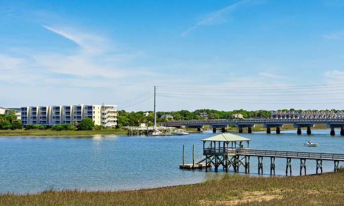 Waters Edge Casa | Water's Edge 114 - River Daze - Premier Riverfront Townhome - Pool & Fishing Pier!